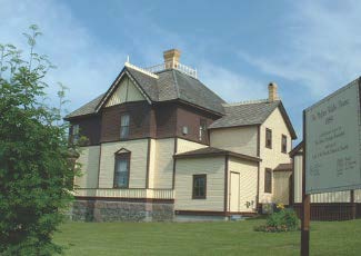 historic home with yellow siding and brown trim